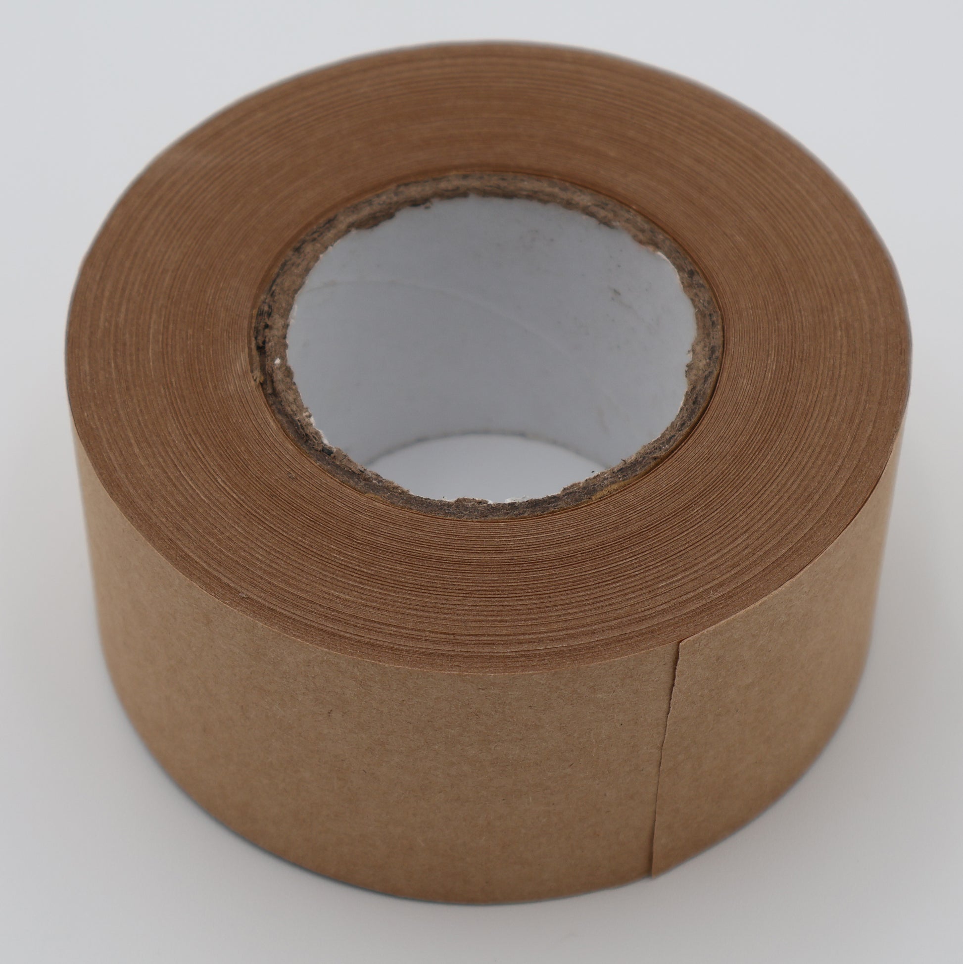 Brown kraft paper packing tape roll showing biodegradable paper texture
